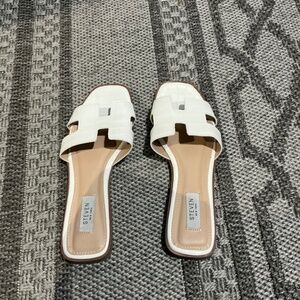 White sandals from the brand Steven New York at women’s size 8 1/2.